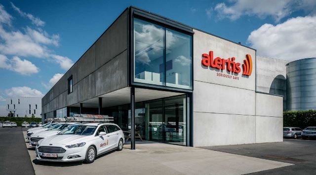 alertis building with cars sitting out front