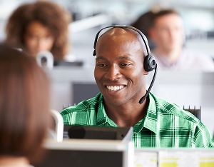 Male collector talking on a headset in an office