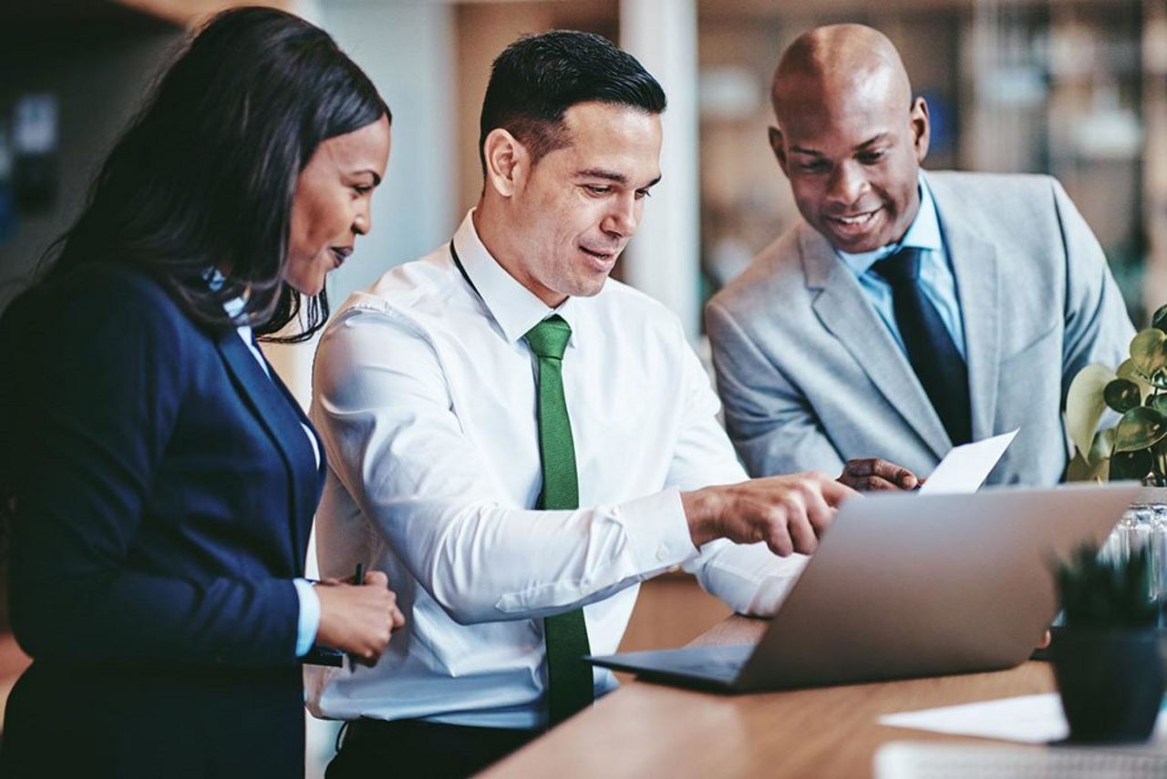 Group of professionals consulting a computer together