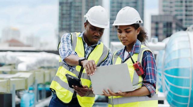 Two workers using digital technology