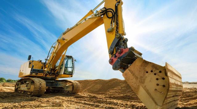 heavy machinery digging through dirt